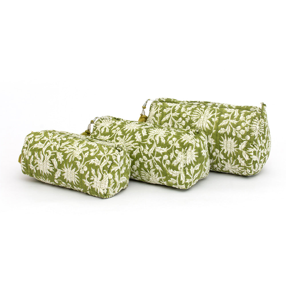 Photo of three forest green and white floral block printed quilted cosmetic pouches showing the three different size options.