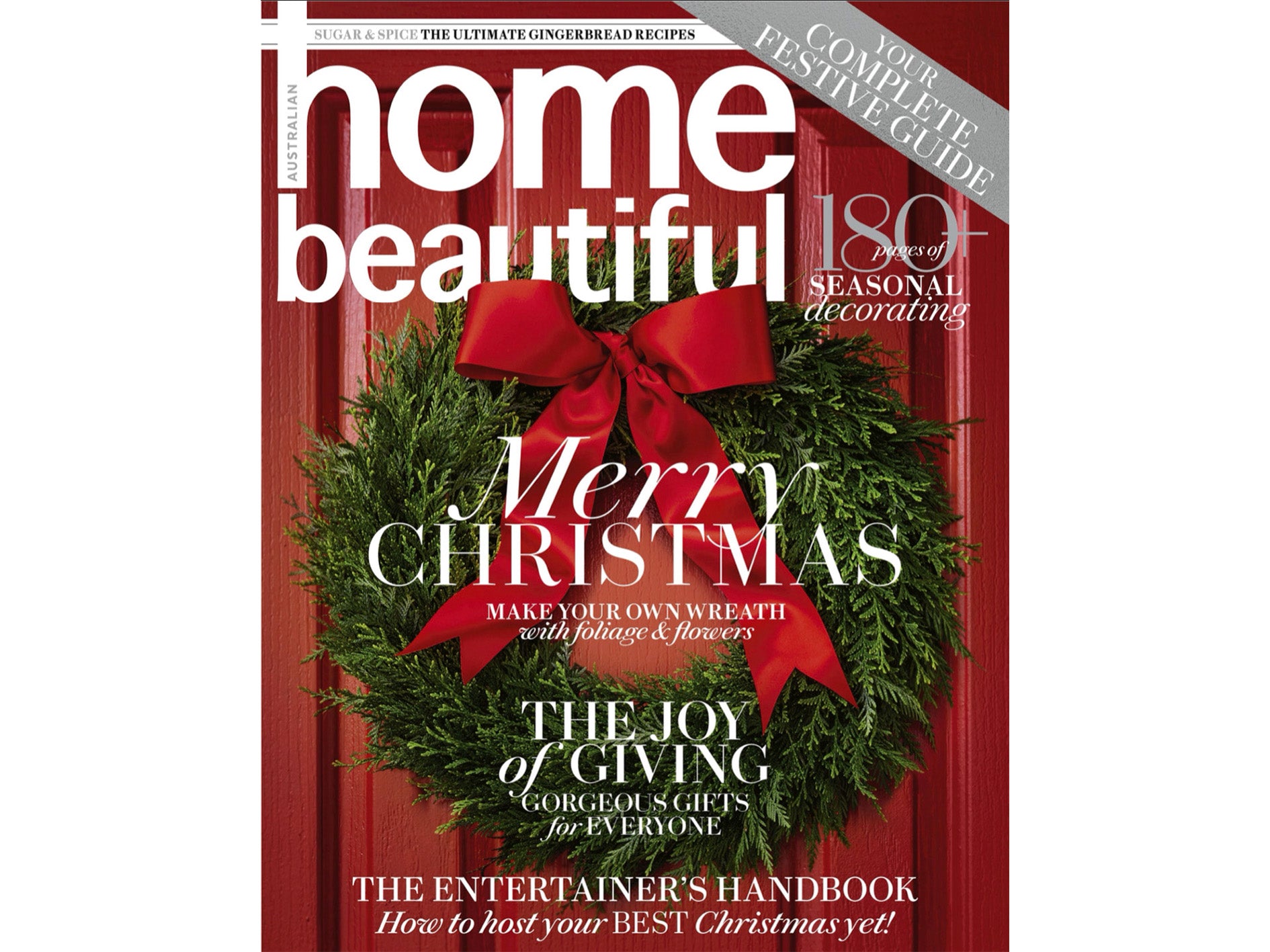 Close up photo of the cover of December 2023 Home Beautiful magazine. The photo is of a red door with a green wreath with a red bow.
