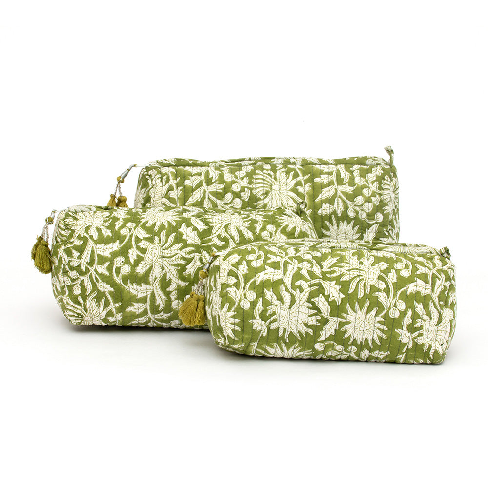 Photo of three forest green and white floral block printed quilted cosmetic pouches showing the three different size options.