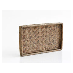 Photo of a rattan bedside tray sitting up on one edge in an old grey finish.