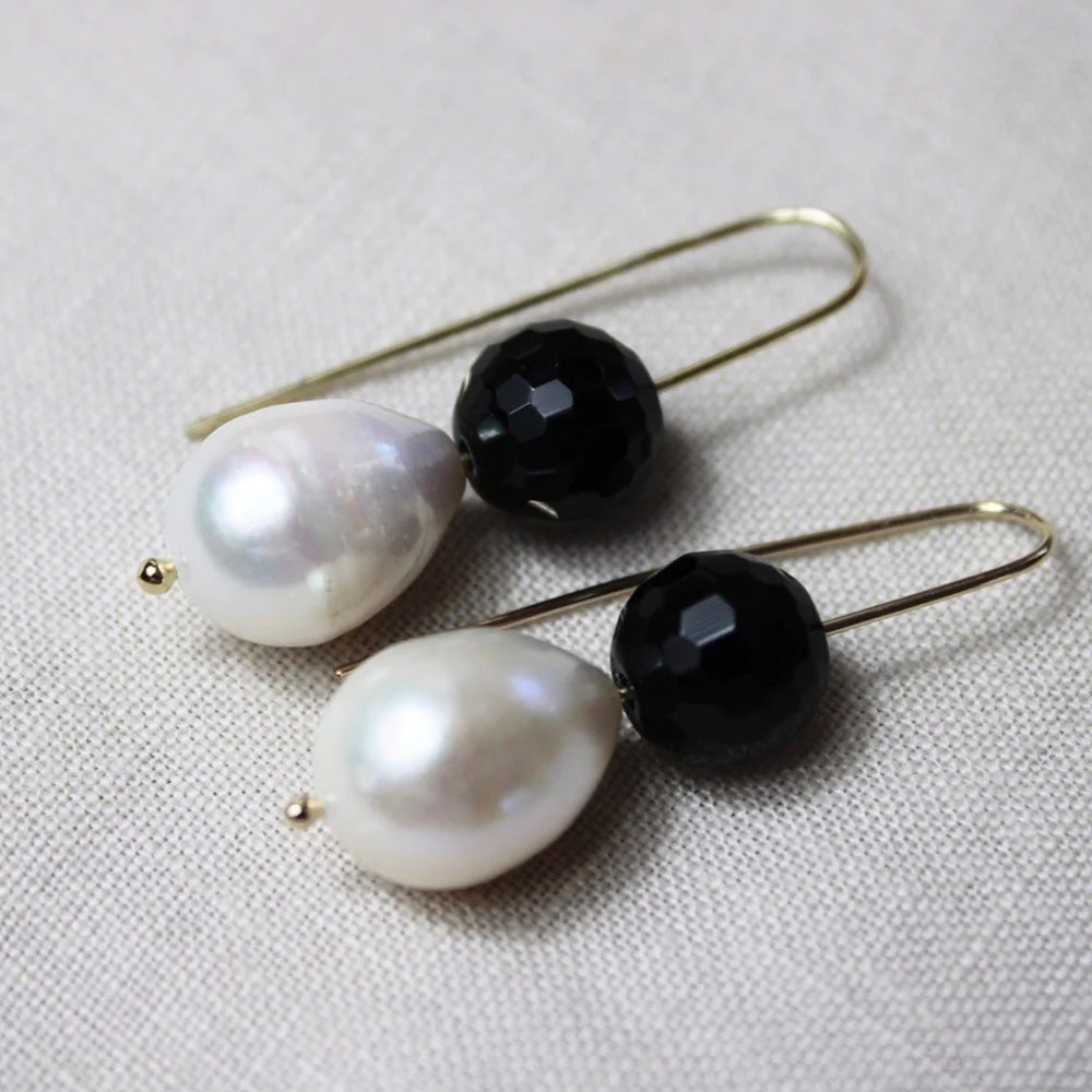 Photo of gold plated hook earrings with a black cut glass-look ball and pearl.