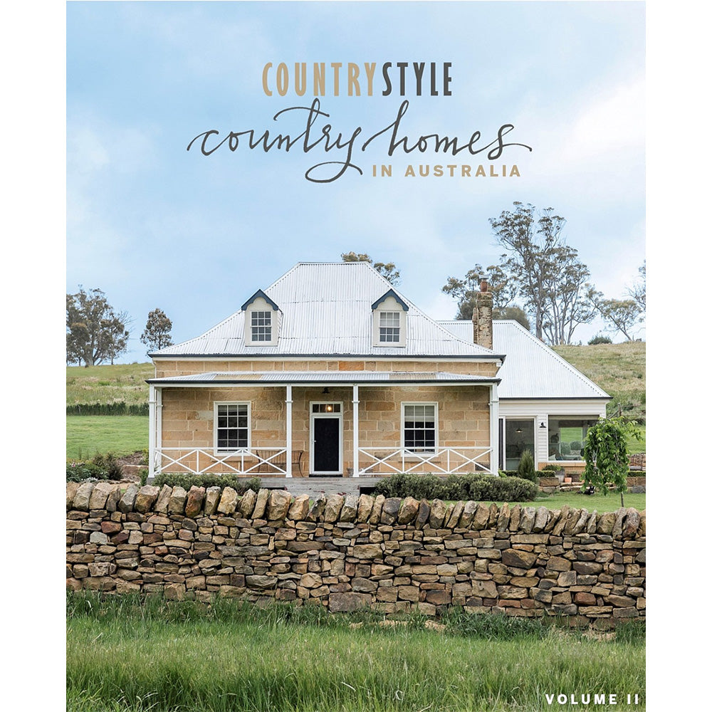 Photo of the cover of Country Homes in Australia volume 2 book which has a stone cottage with a stone wall in front of it.