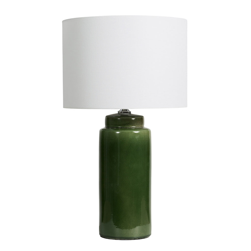 Photo of deep glossy emerald green ceramic lamp with a plain white drum shade.