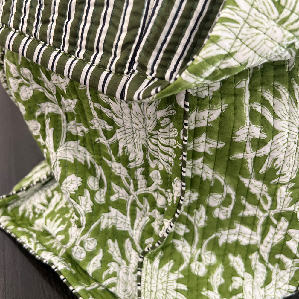 Close up photo of forest green block printed quilted tote bag showing the inside striped fabric.