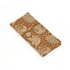 Photo of a folded cream and spice brown cotton napkin.