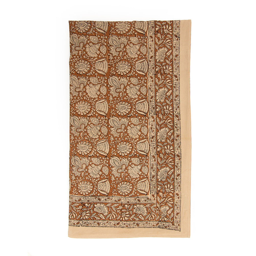 Photo of a folded cream and spice brown cotton tablecloth.