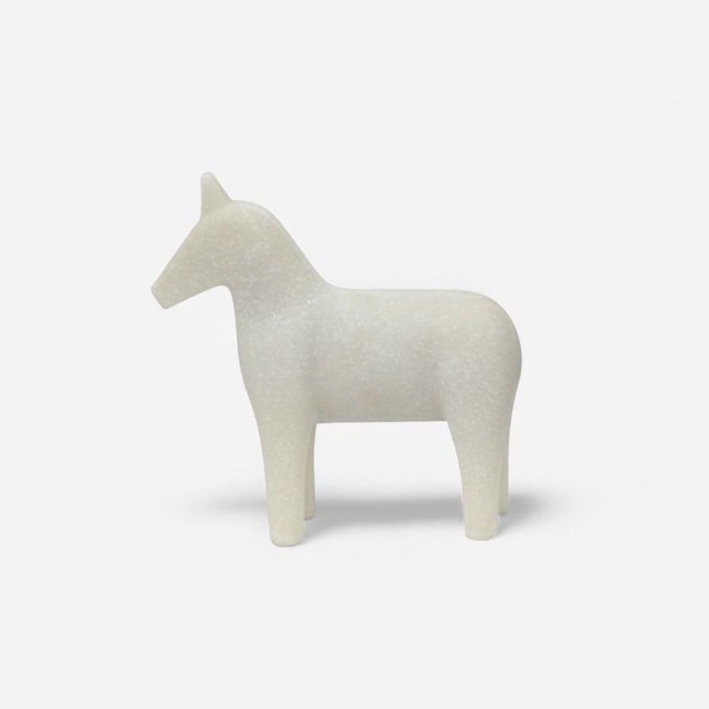White horse-shaped object on a light gray background