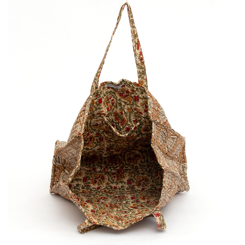 Photo of coffee spice block printed quilted tote bag showing the inside floral fabric and inside pocket.