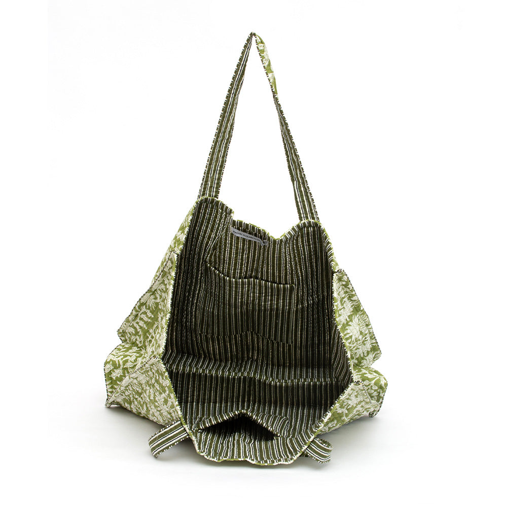 Photo of forest green block printed quilted tote bag showing the inside striped fabric and inside pocket.