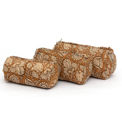 Photo of three coffee spice block printed quilted cosmetic pouches showing the three different size options.