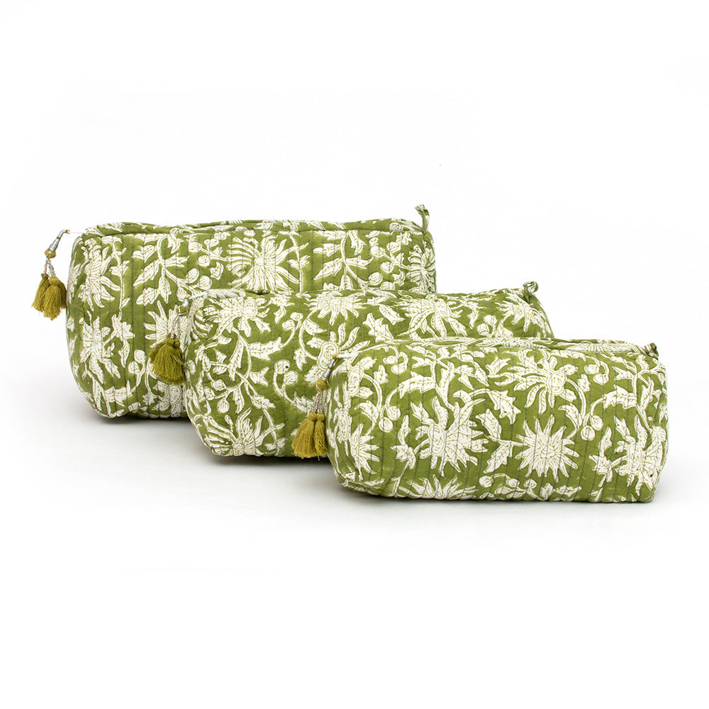 Photo of three forest green and white floral block printed quilted cosmetic pouches showing the three different size options.