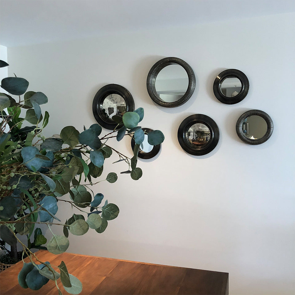 Photo of a combination of antique convex mirrors, antique mirrors and ring accent mirrors in different sizes