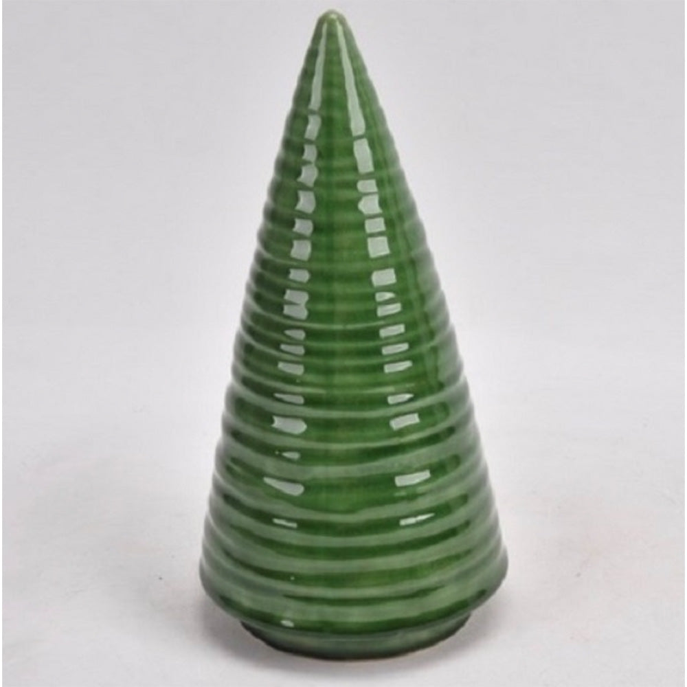Close up shiny green ceramic cone shaped Christmas tree table decoration