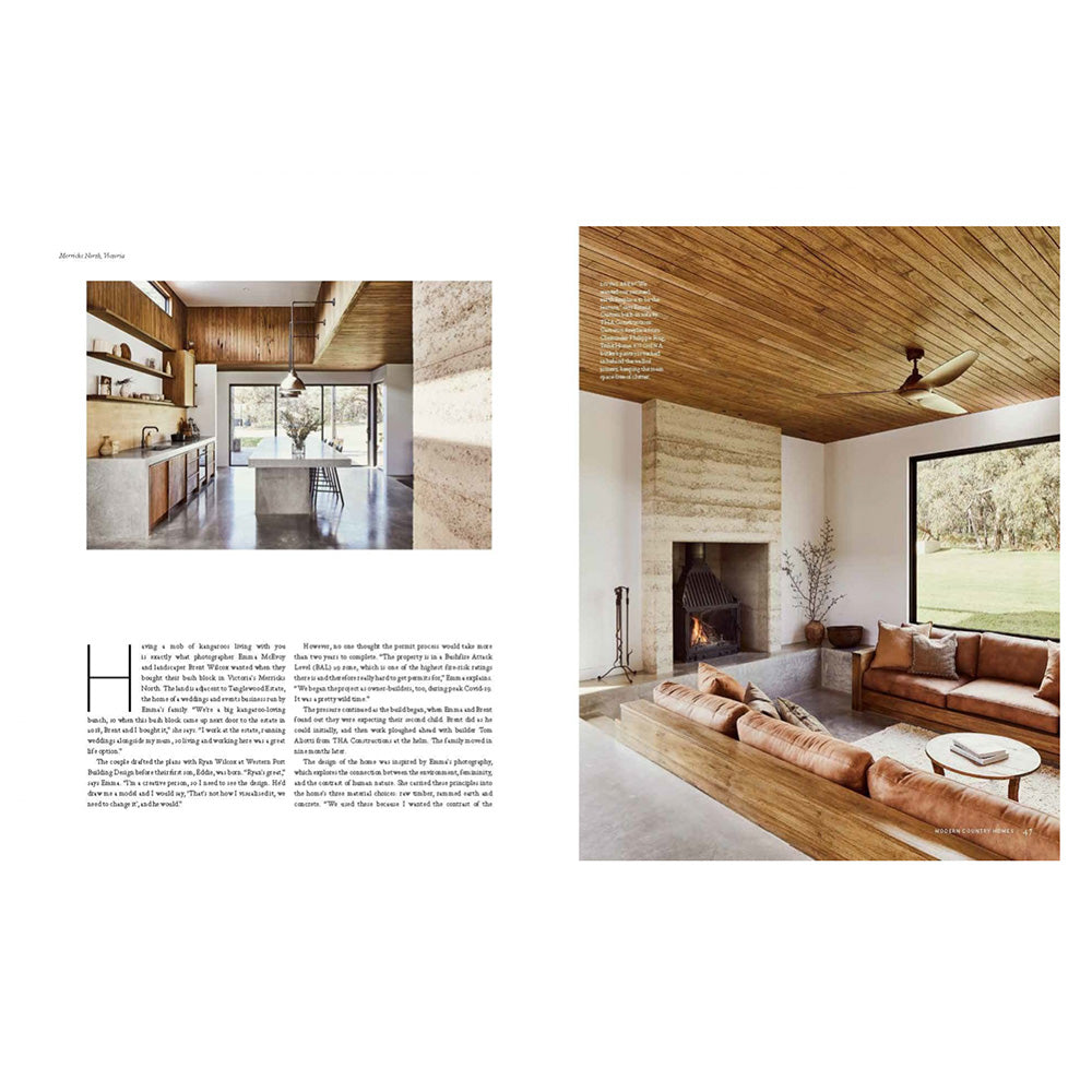 Photo of the inside page of Modern Country Homes book with a photo of a kitchen on the left and a sunken lounge seating area on the right.