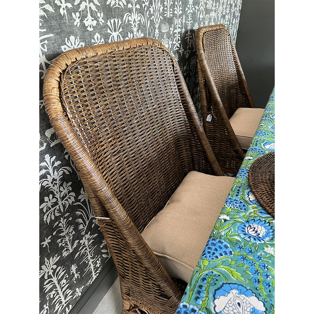 Photo of dark antique finish rattan dining chair with cream seat cushion