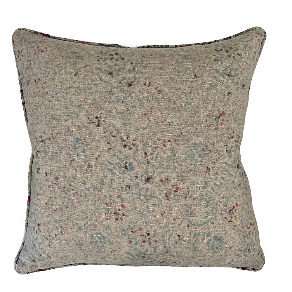 Photo of linen cushion showing up close pattern of blue and pink floral on beige linen  