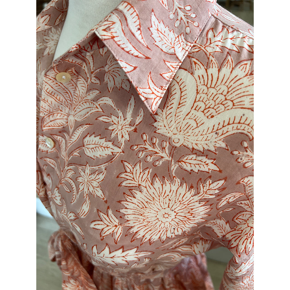 Photo showing fabric detail and pattern on Adaline Dress in coral flower on beige background