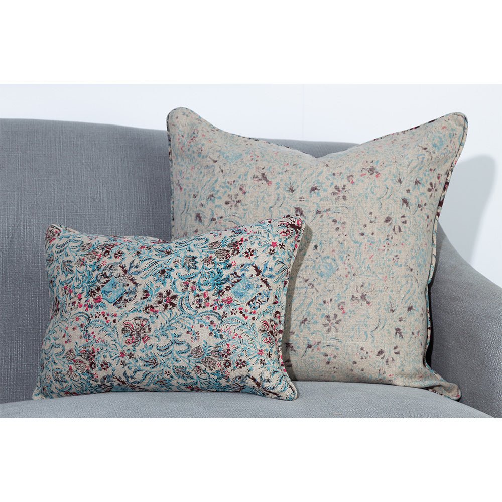 Photo of linen cushion showing up close pattern of blue and pink floral on beige linen in both the front and reverse side of the fabric.