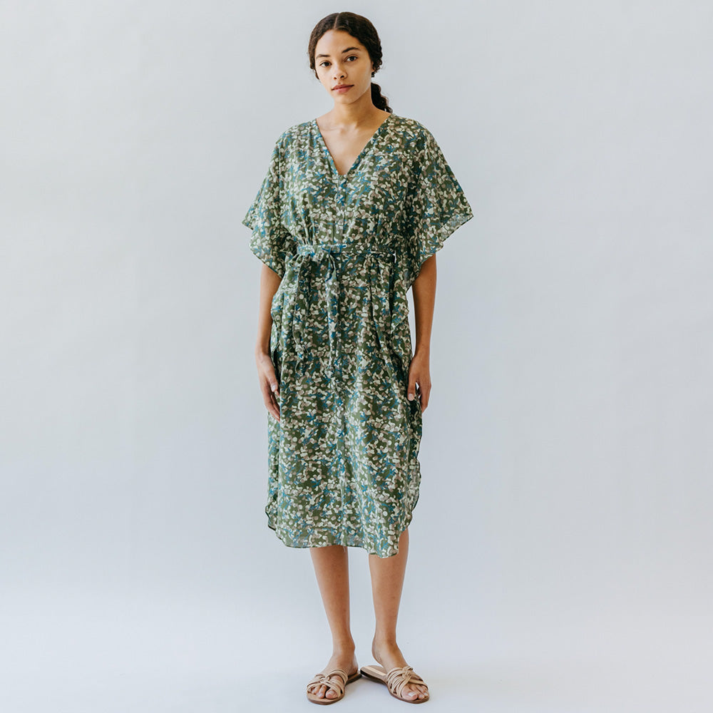 Photo of model wearing green and yellow spot cotton fabric Bali dress by Mirth