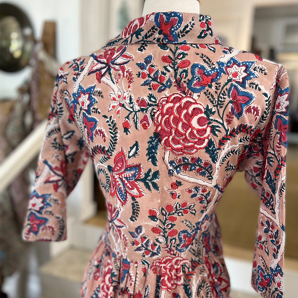 Photo showing fabric detail and pattern on the back of the Adaline Dress in raspberry pink floral