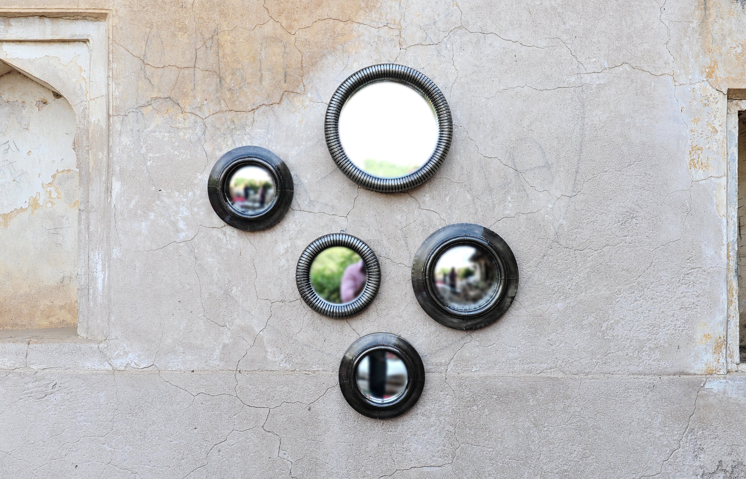 Photo of a combination of antique convex mirrors, antique mirrors and ring accent mirrors in different sizes