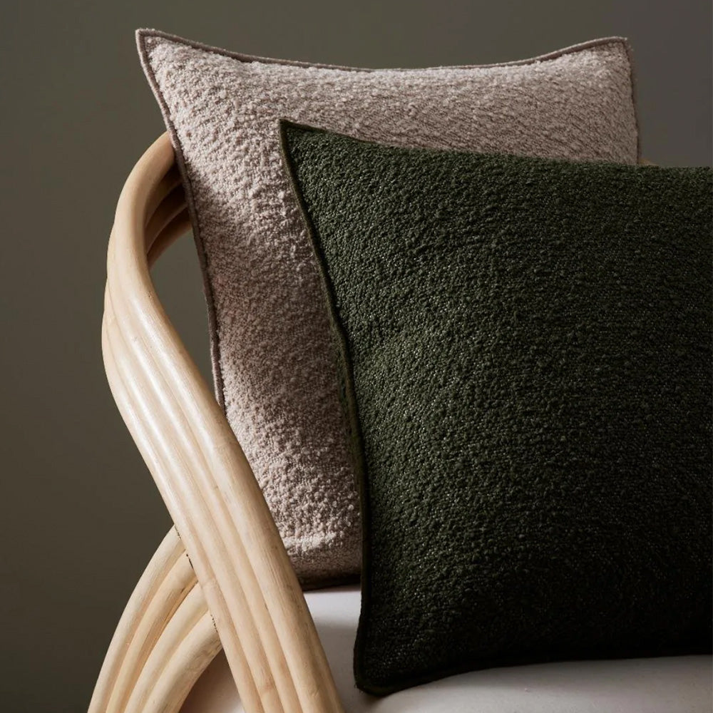 Photo of olive green and coffee coloured boucle cushions on a chair