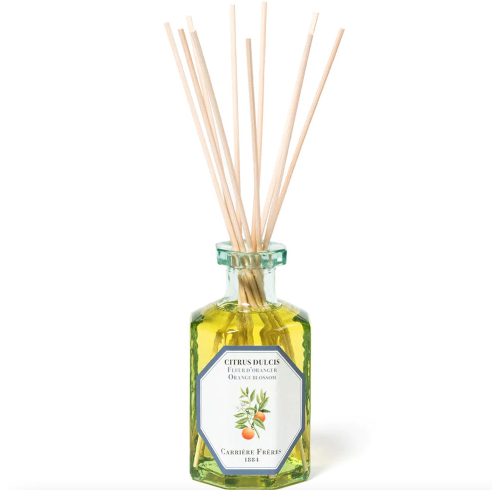 Photo of orange blossom scented room diffuser bottle and sticks made by Carriere Freres