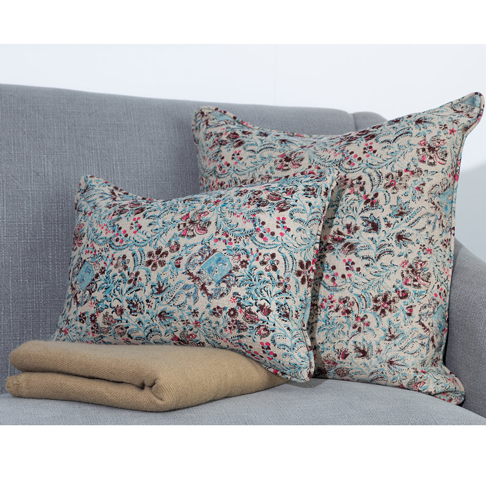 Photo of linen cushion showing up close pattern of blue and pink floral on beige linen